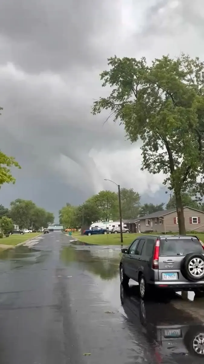 This may contain: cars parked on the side of a wet road