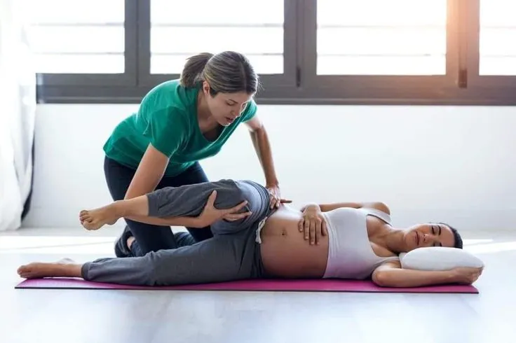 This may contain: a young woman is doing yoga with her instructor