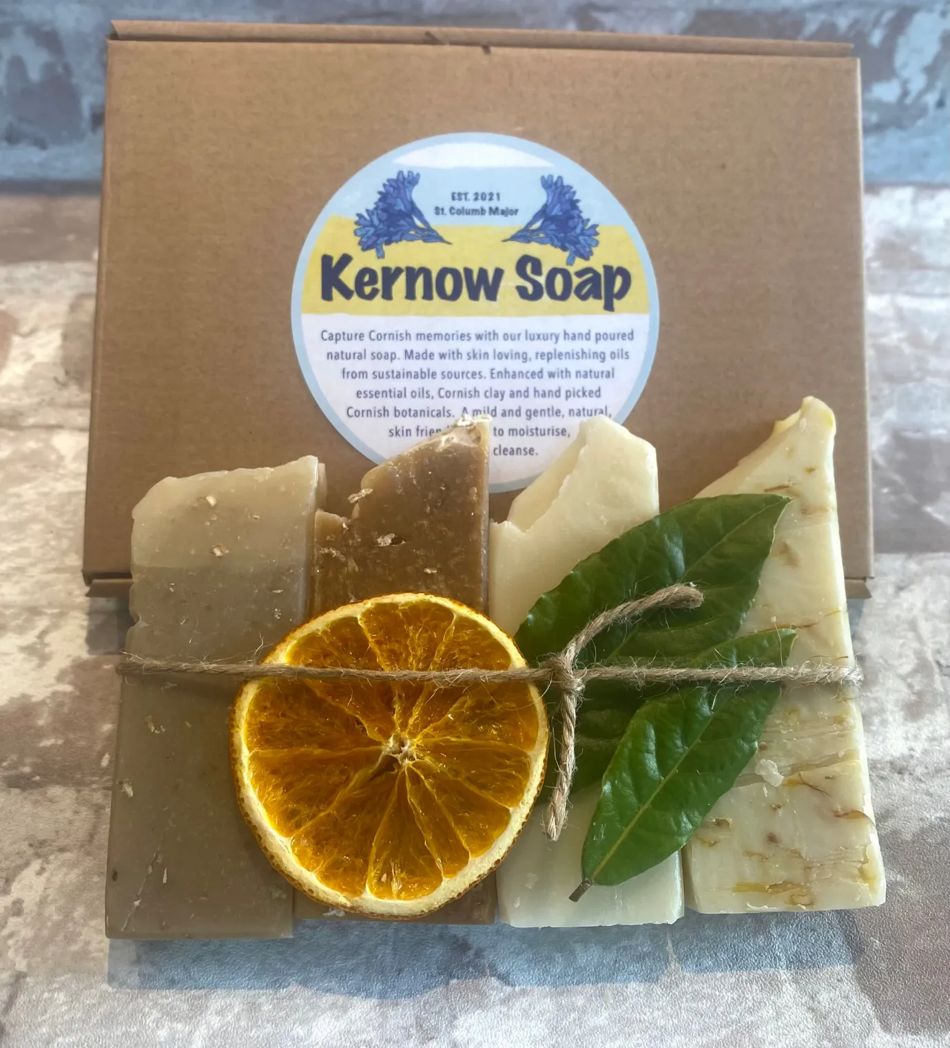 A box set featuring four bars of soap presented in a card box with the Kernow Soap label and a graphic of a bee on the top.
