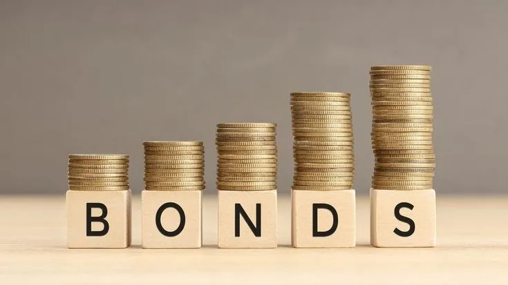 This may contain: stacks of coins with the word bonds spelled on them
