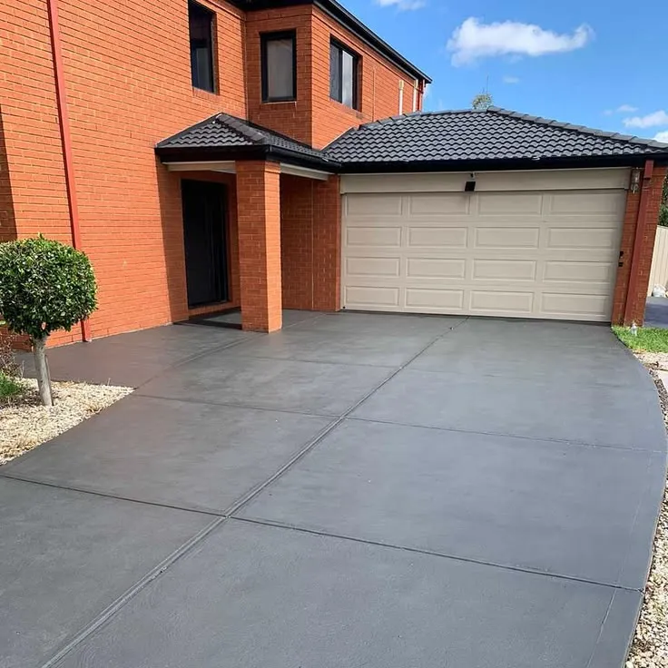 This may contain: a house with a driveway in front of it and two garages on the other side