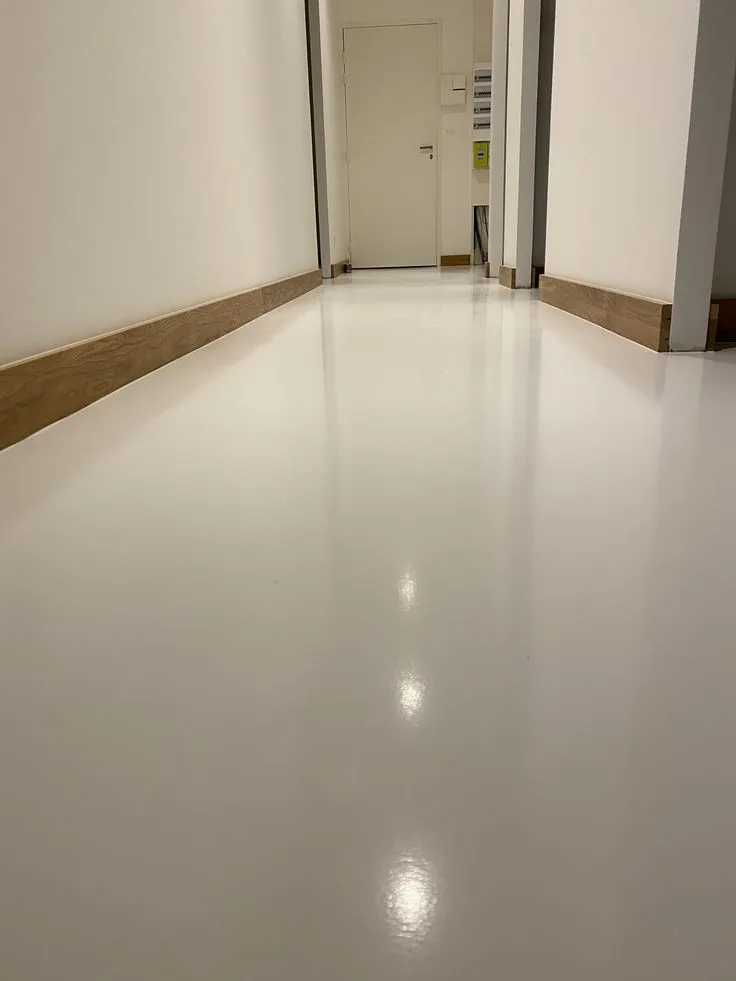 This may contain: an empty room with white walls and floors