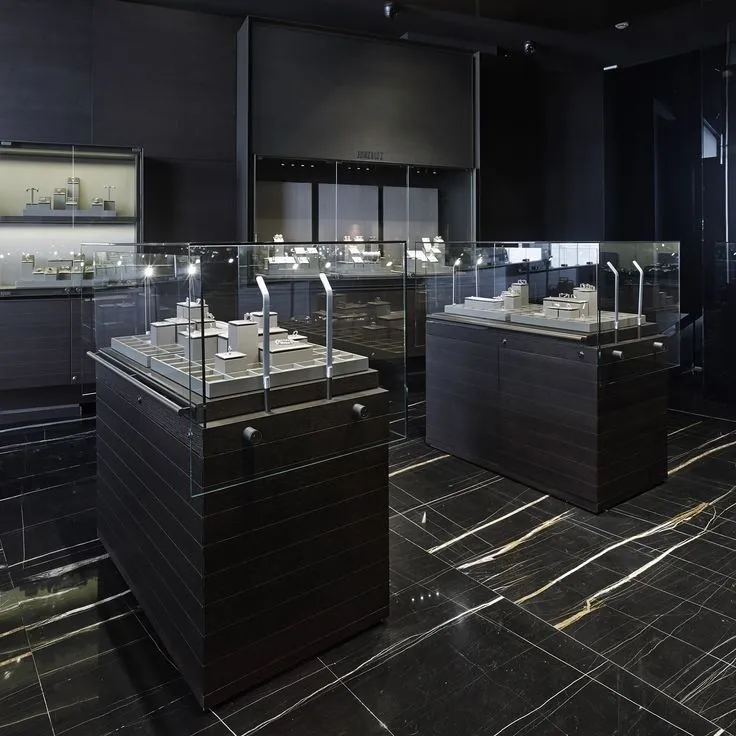 This may contain: a room filled with lots of black and white jewelry cases next to each other on display shelves