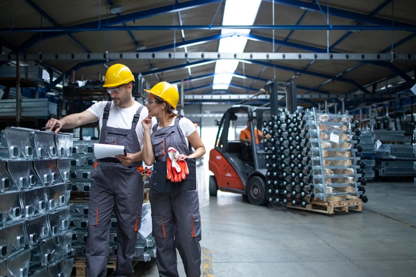 factory workers checking quality of products in industrial warehouse