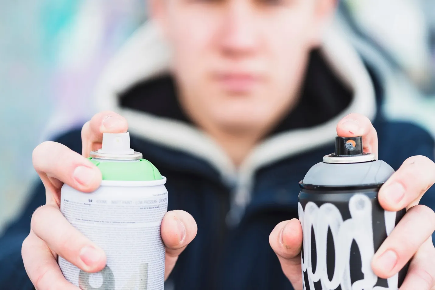 man holding spray in hand