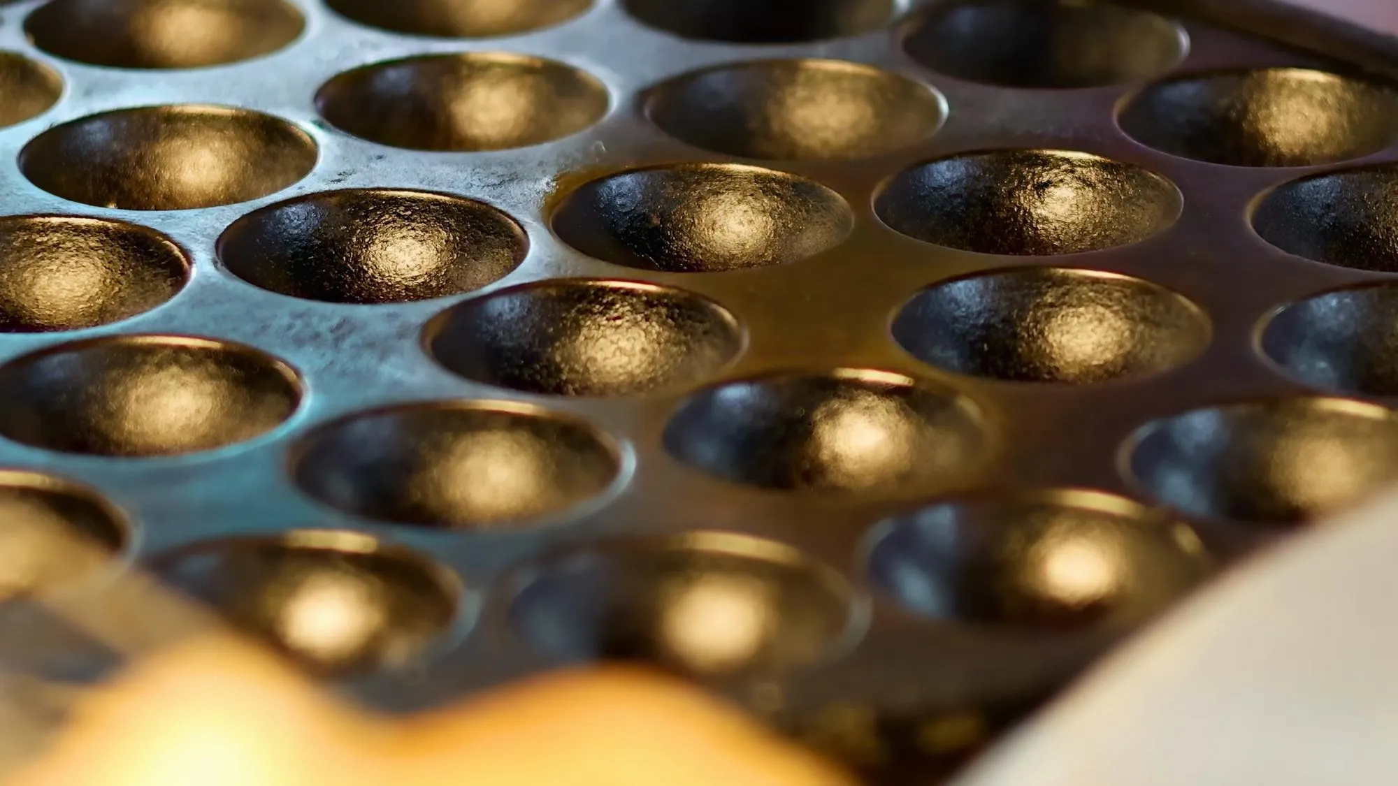 closeup view of a cast iron pan with multiple circular molds