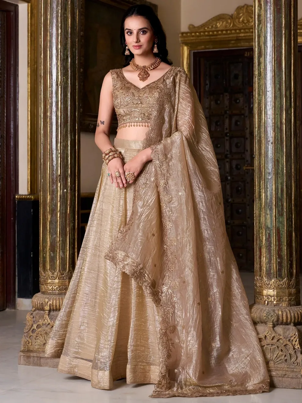 Elegant gold embroidered lehenga choli with dupatta, perfect for Indian weddings and festive occasions.