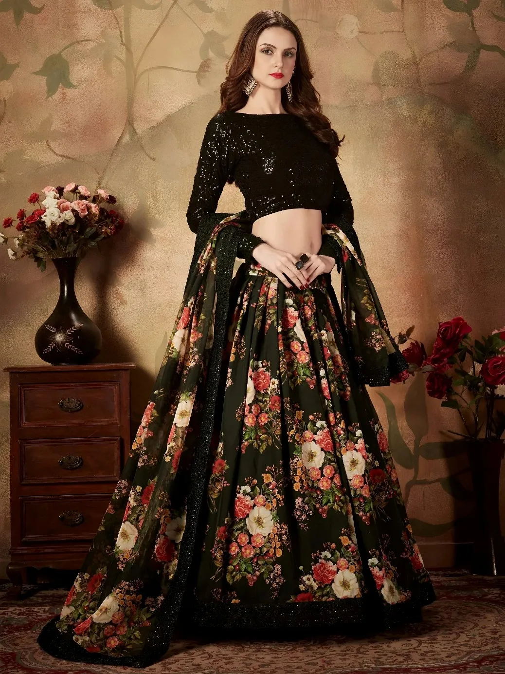 Woman wearing a black sequined blouse and floral print lehenga choli with a matching dupatta