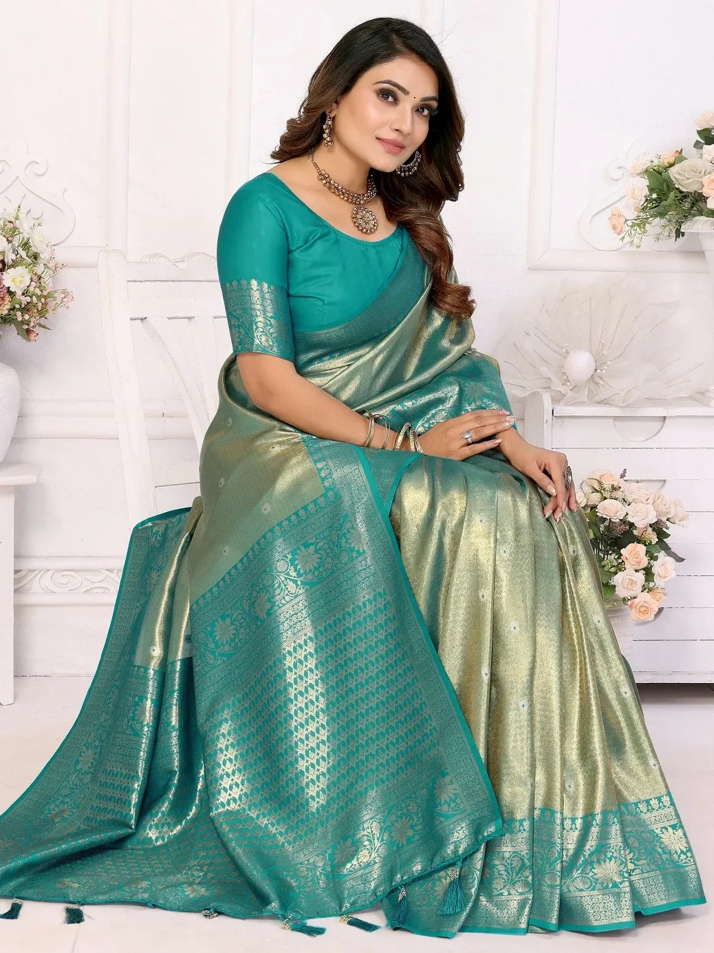 Elegant teal and gold saree with intricate patterns, perfect for ethnic occasions