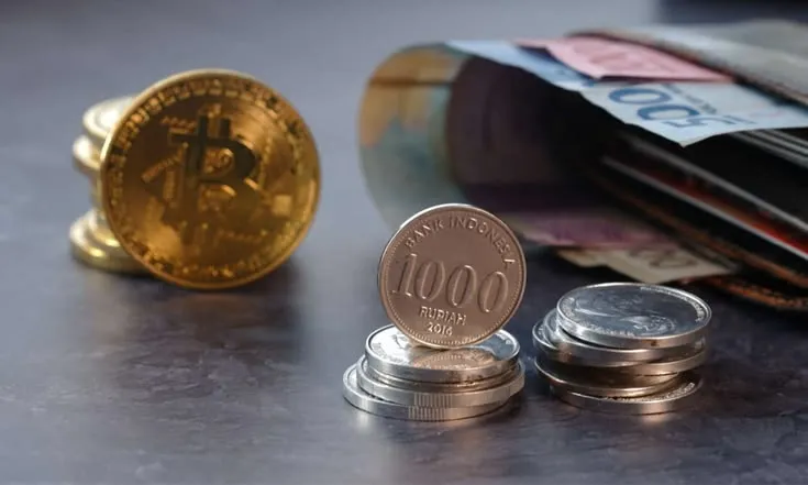 This may contain: two stacks of coins sitting on top of each other next to a stack of money